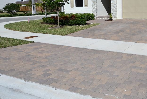 Residential paver driveway with palm trees